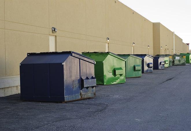 a compact construction dumpster being emptied by a waste disposal truck in Bethany